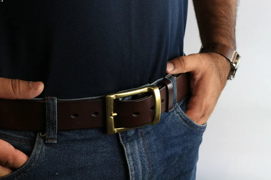 a man wearing a brown leather belt with gold buckle