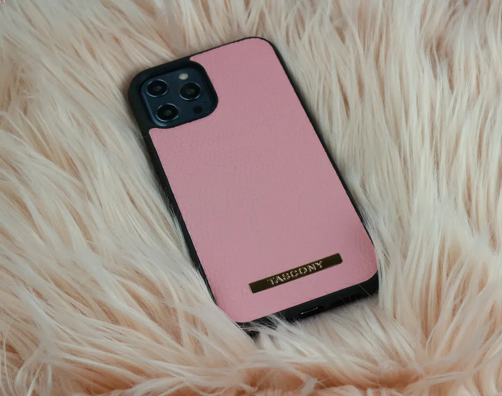 iphone 12 mini phone case in pink colour is sitting on rug , giving beautiful representation . Best Choice of ladies in Australia.