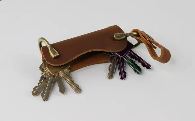 leather keychain to secure more than 10 keys , it has button closer at the top to keep keys invisible .