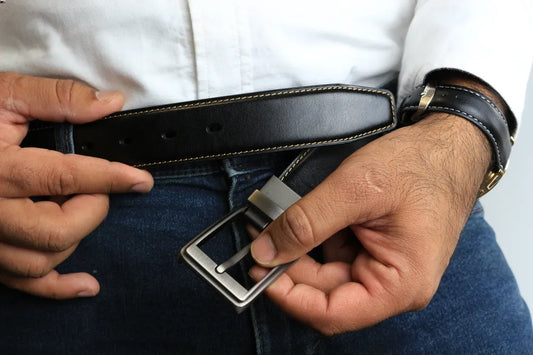 a person putting a belt in their pants