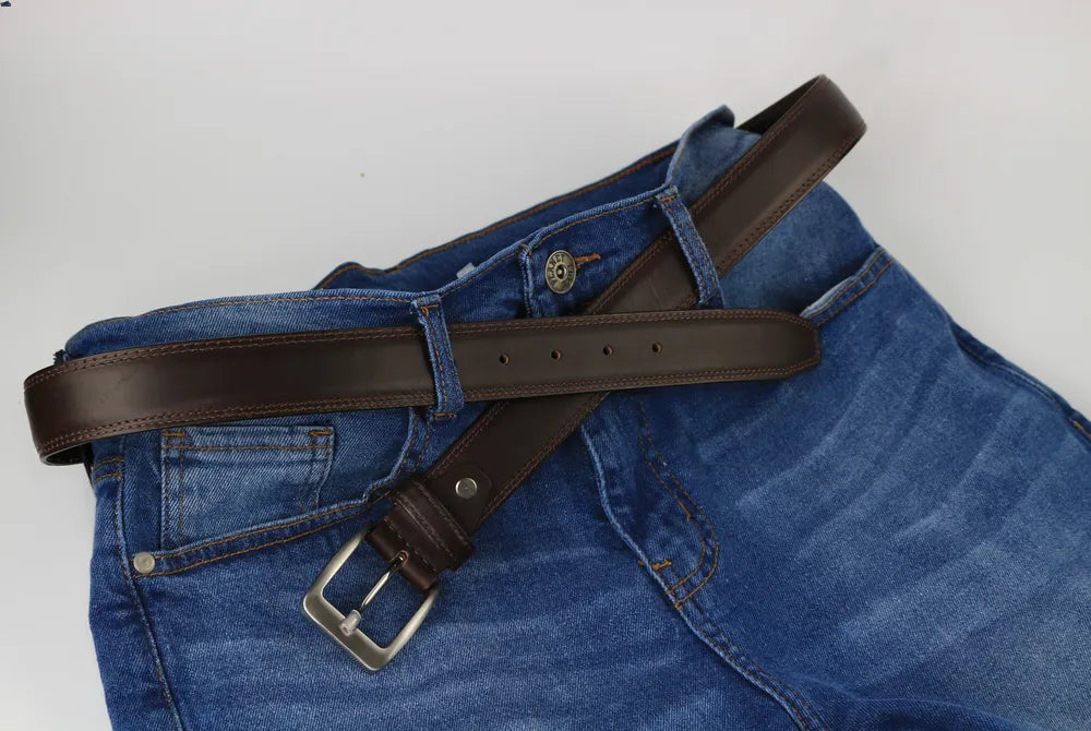 a pair of blue jeans with a brown belt