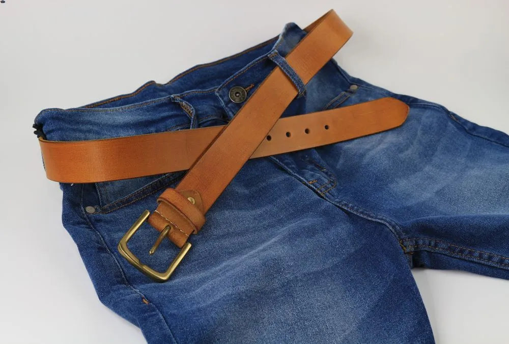 a pair of blue jeans with a brown belt
