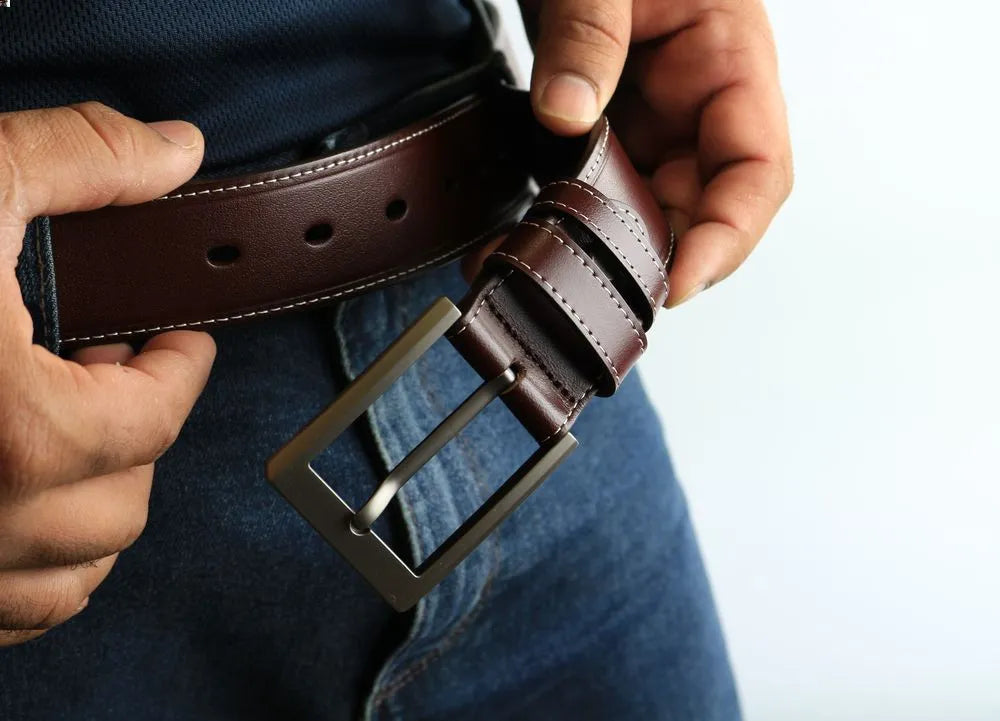 a person holding a leather belt